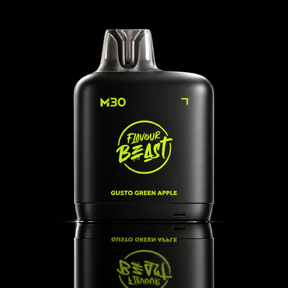 A black vape device labeled 'Flavour Beast M30' with green apple graphics and the text 'GUSTO GREEN APPLE' on a dark neon-lit background.